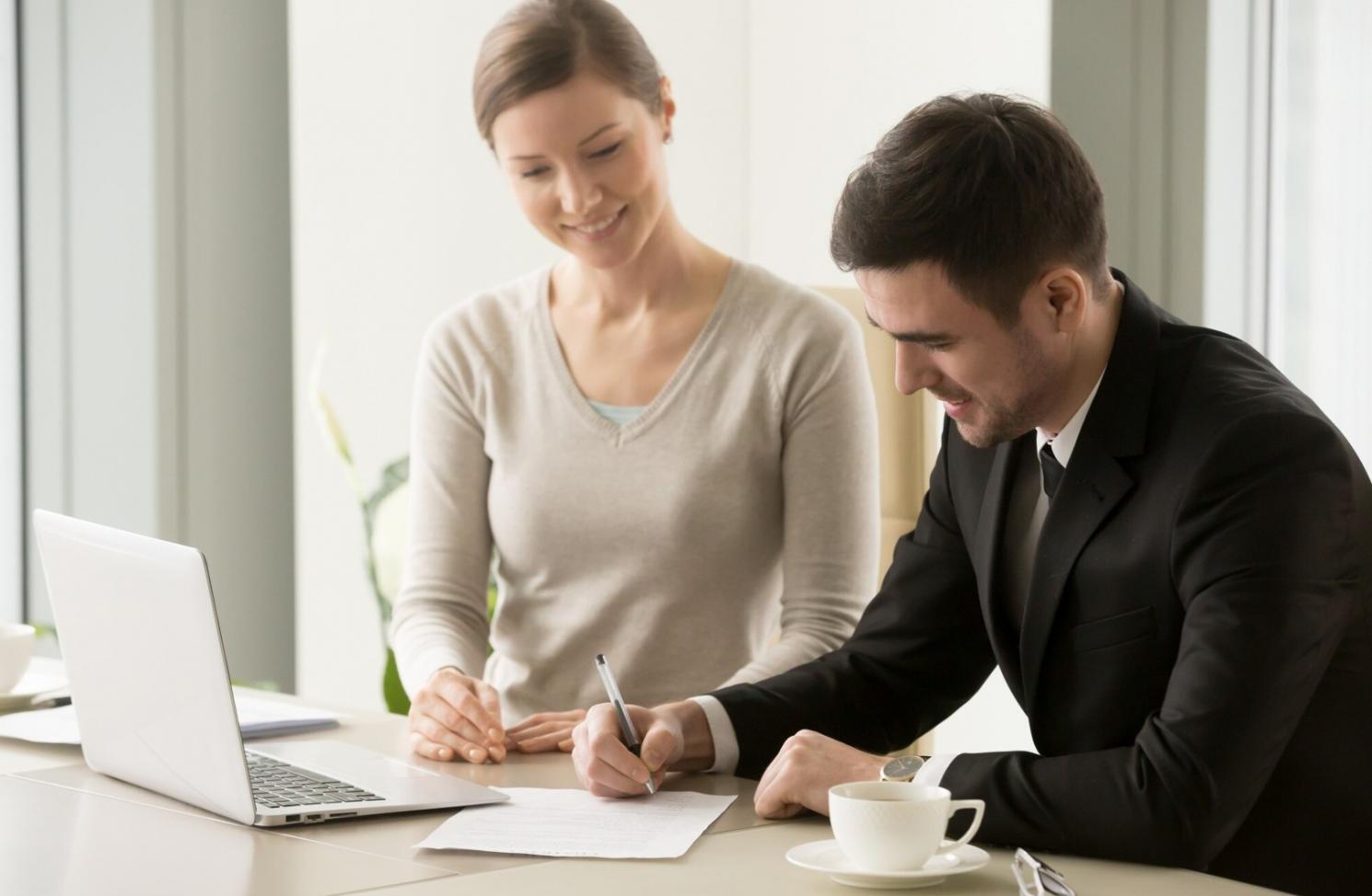 Financial planning workspace with documents and laptop